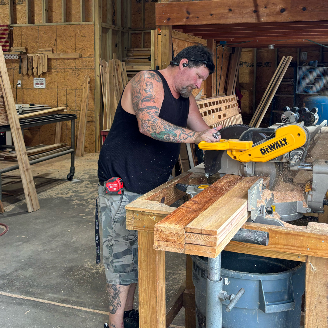 Chesapeake Fence craftsperson cutting wood in the workshop