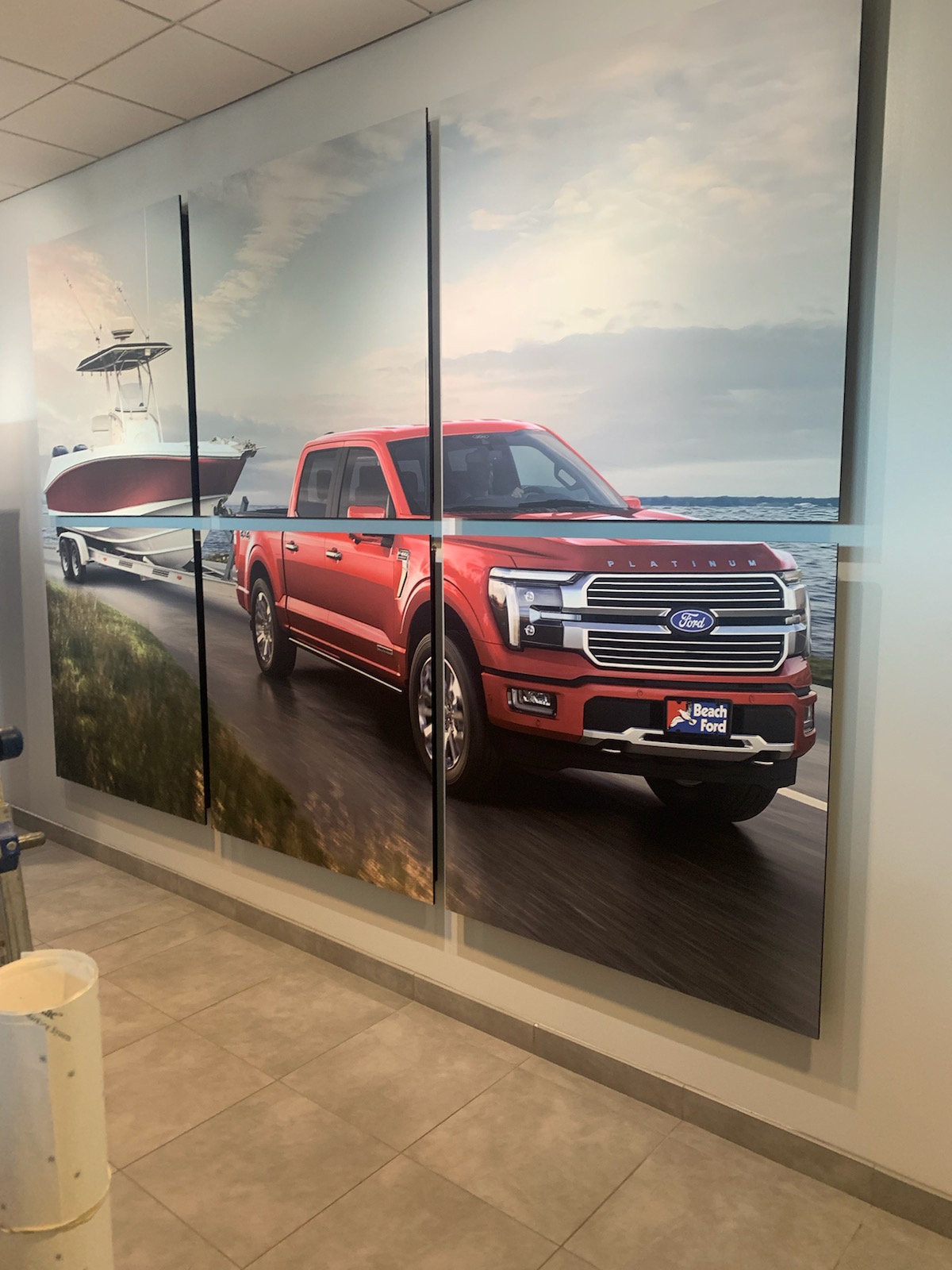Beach Ford red truck artwork installed in the dealership showroom